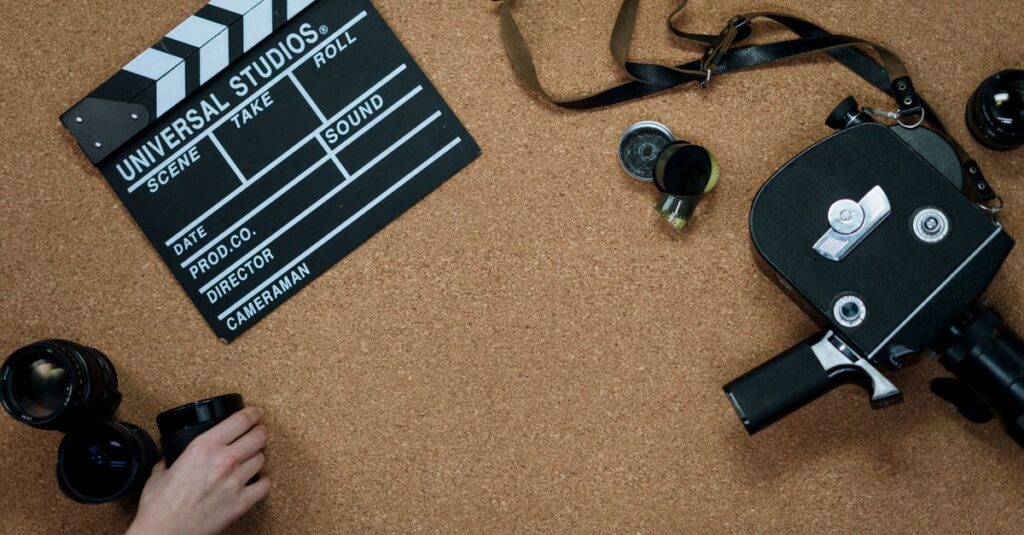Flat lay of vintage film equipment and clapperboard on corkboard. Ideal for cinema and filmmaking concepts.