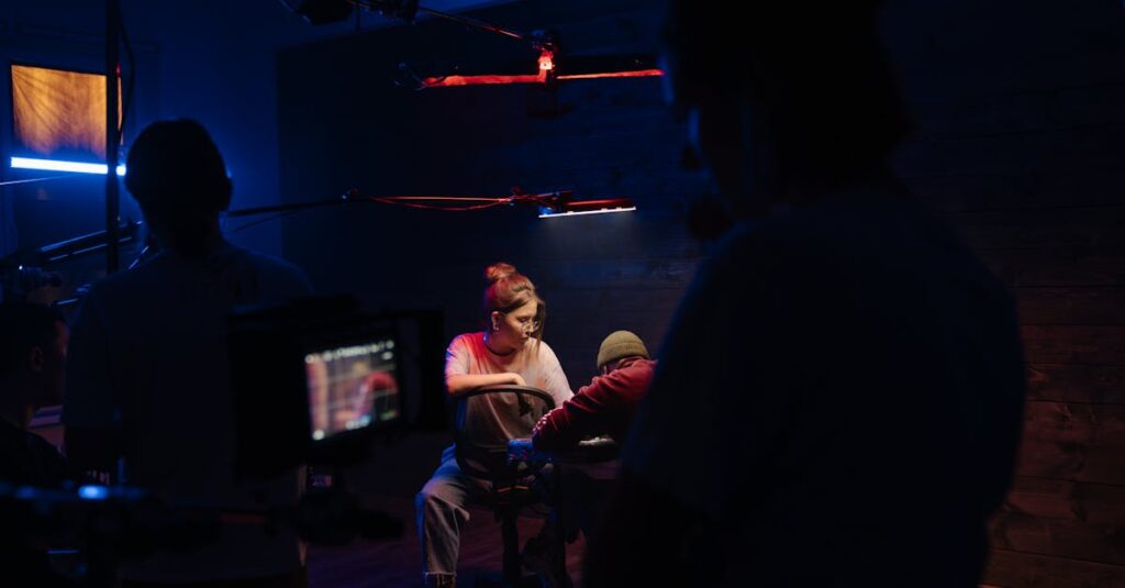 Indoors film set illuminated by neon lights, showcasing a camera crew in action.
