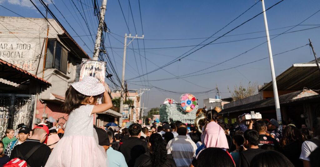 Lively street scene during a parade in Tultepec, showcasing local culture and festivities.