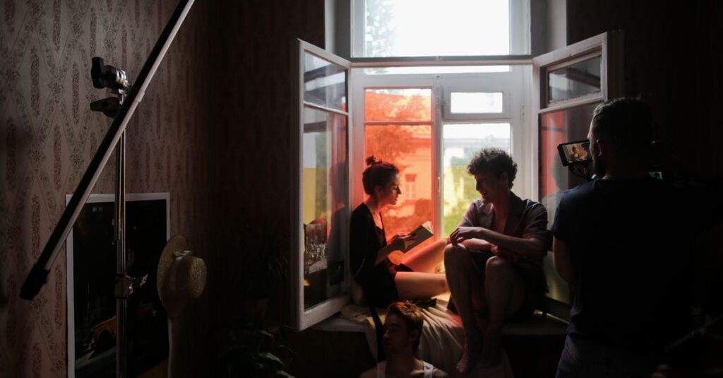 A behind-the-scenes look at a creative film shoot with models in natural light.