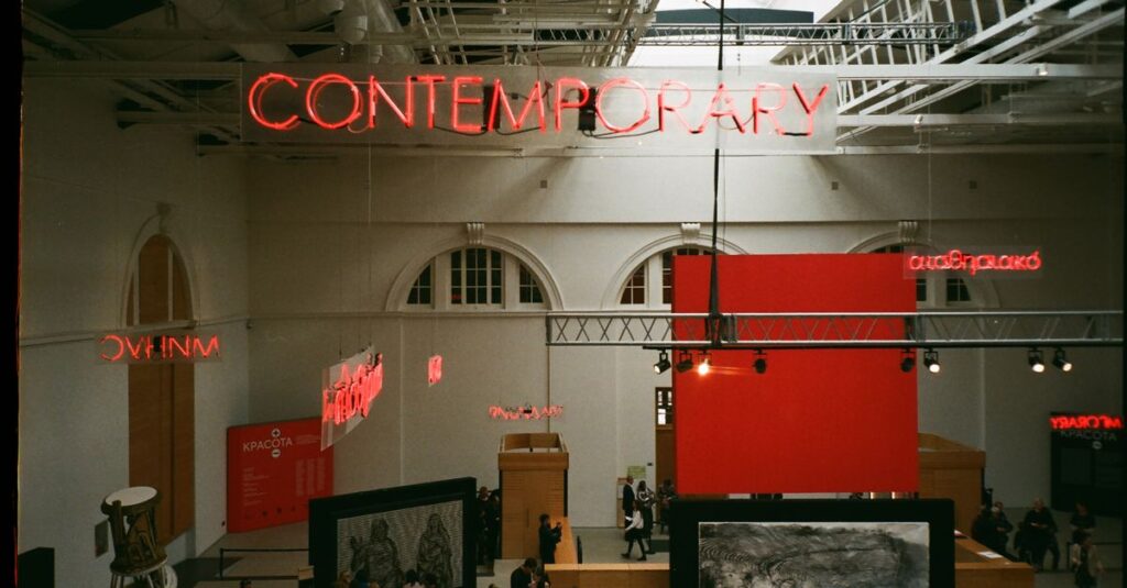View of a contemporary art exhibition in a modern gallery, showcasing unique displays and architecture.