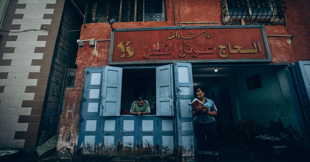 A candid street scene in Damietta, capturing local life outside a traditional shop.