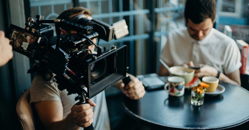 Cameraman filming a scene in a cozy cafe setting, capturing the cinematic atmosphere.
