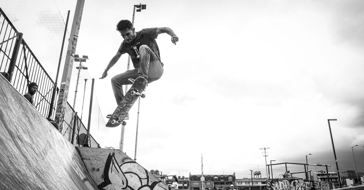 Skateboarder executing a trick in Bogotá skate park, highlighting urban street culture.