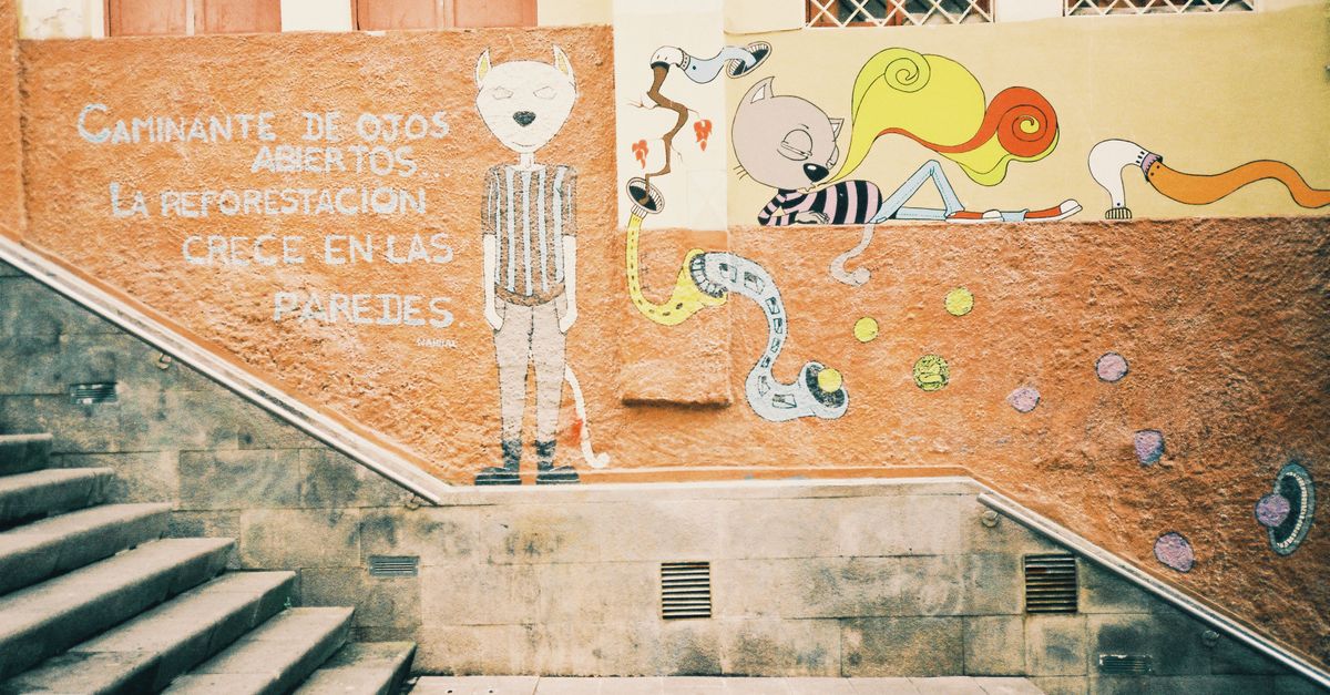 Colorful street art mural in Cuenca capturing urban creativity and cultural expression.