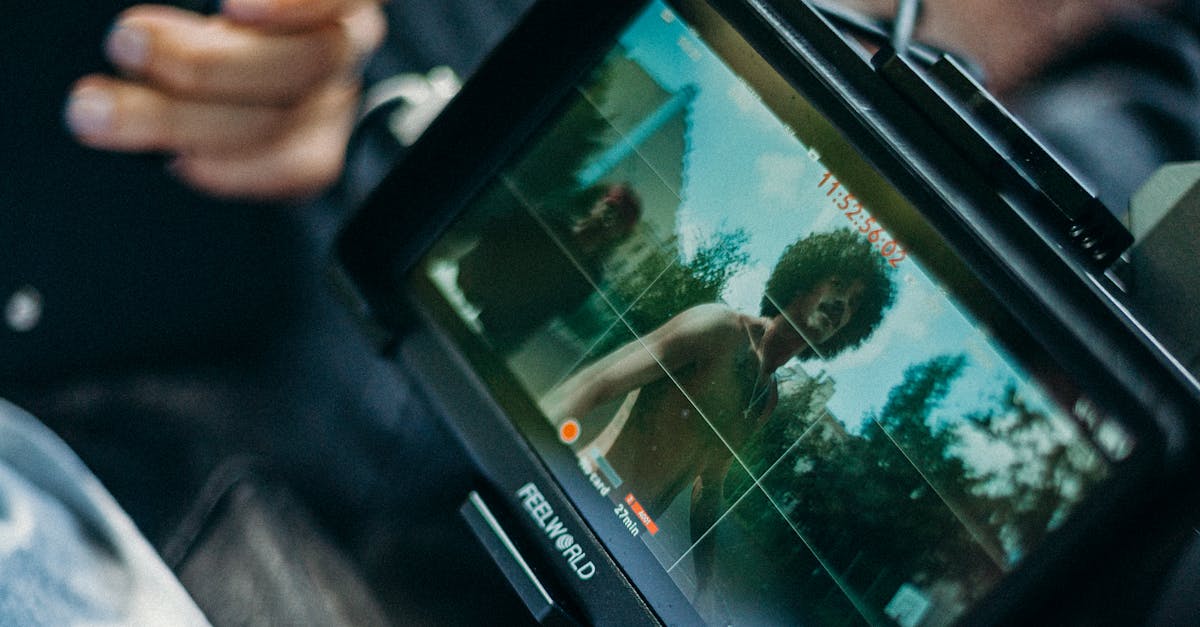 Close-up of a cinematic display showing a filmmaker at work capturing a scene outdoors.
