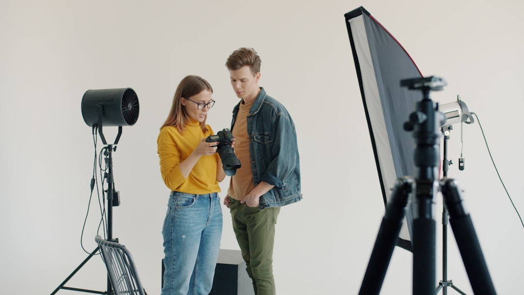 Two people looking at a camera in a studio.