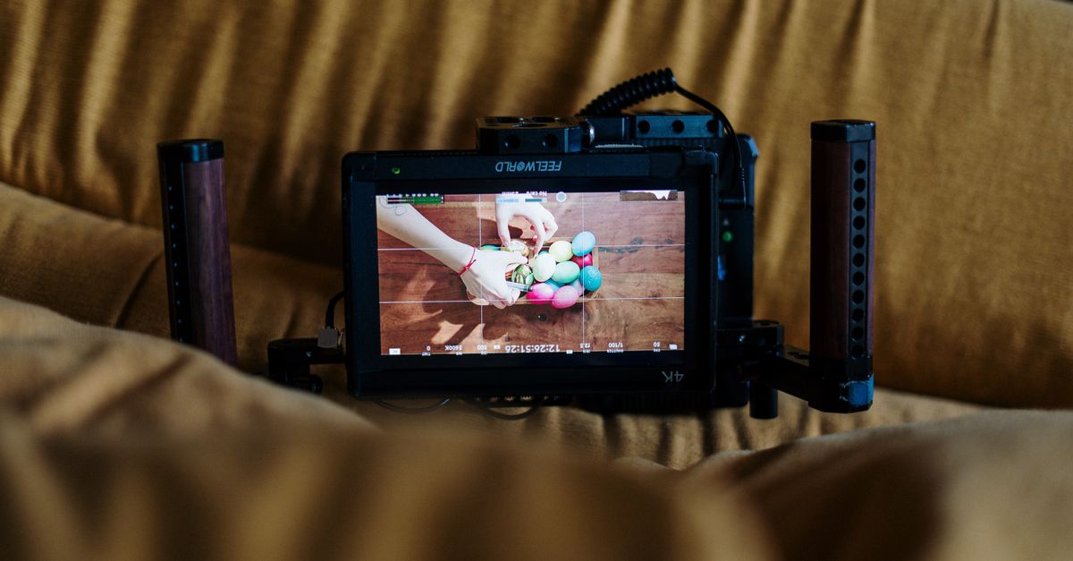 Artistic process of filming colorful Easter egg decoration with a professional camera.