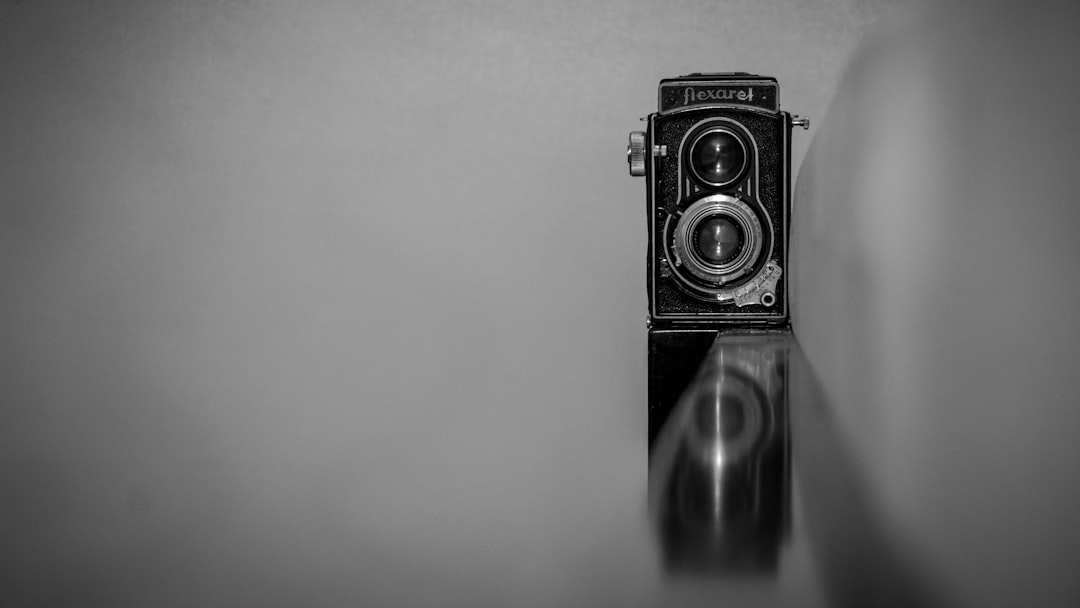a black and white photo of an old camera