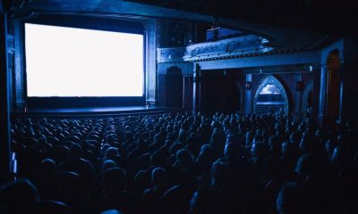 A full cinema theater in Budapest with an audience watching a movie at night.