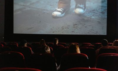 A group of people enjoying a film in a cinema with a large screen.