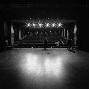grayscale photo of people walking on hall