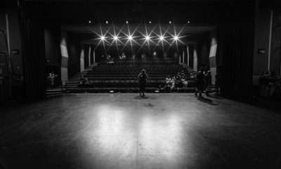 grayscale photo of people walking on hall