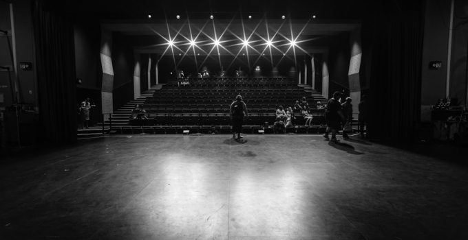 grayscale photo of people walking on hall