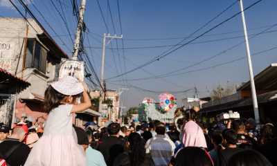 Lively street scene during a parade in Tultepec, showcasing local culture and festivities.