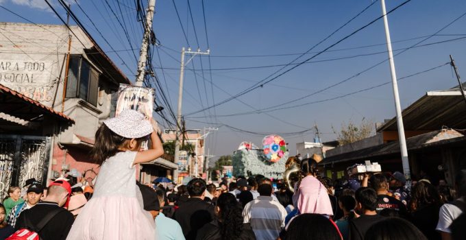 Lively street scene during a parade in Tultepec, showcasing local culture and festivities.