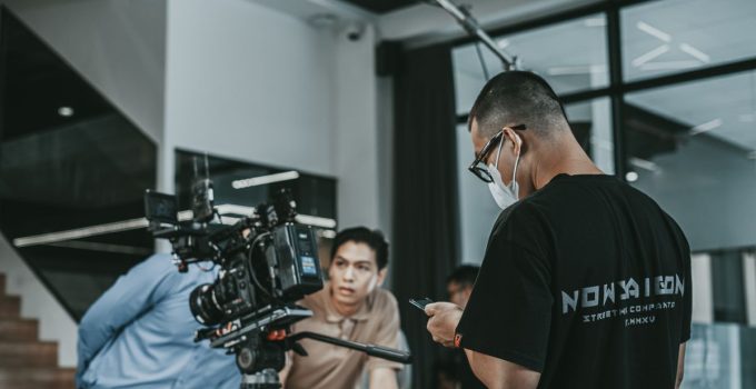 Camera crew working on a film set in Vietnam, capturing cinematic scenes indoors.